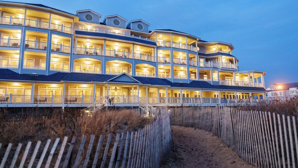 A multi-story hotel with balconies and a beach view. - Madison Beach Hotel (Madison)