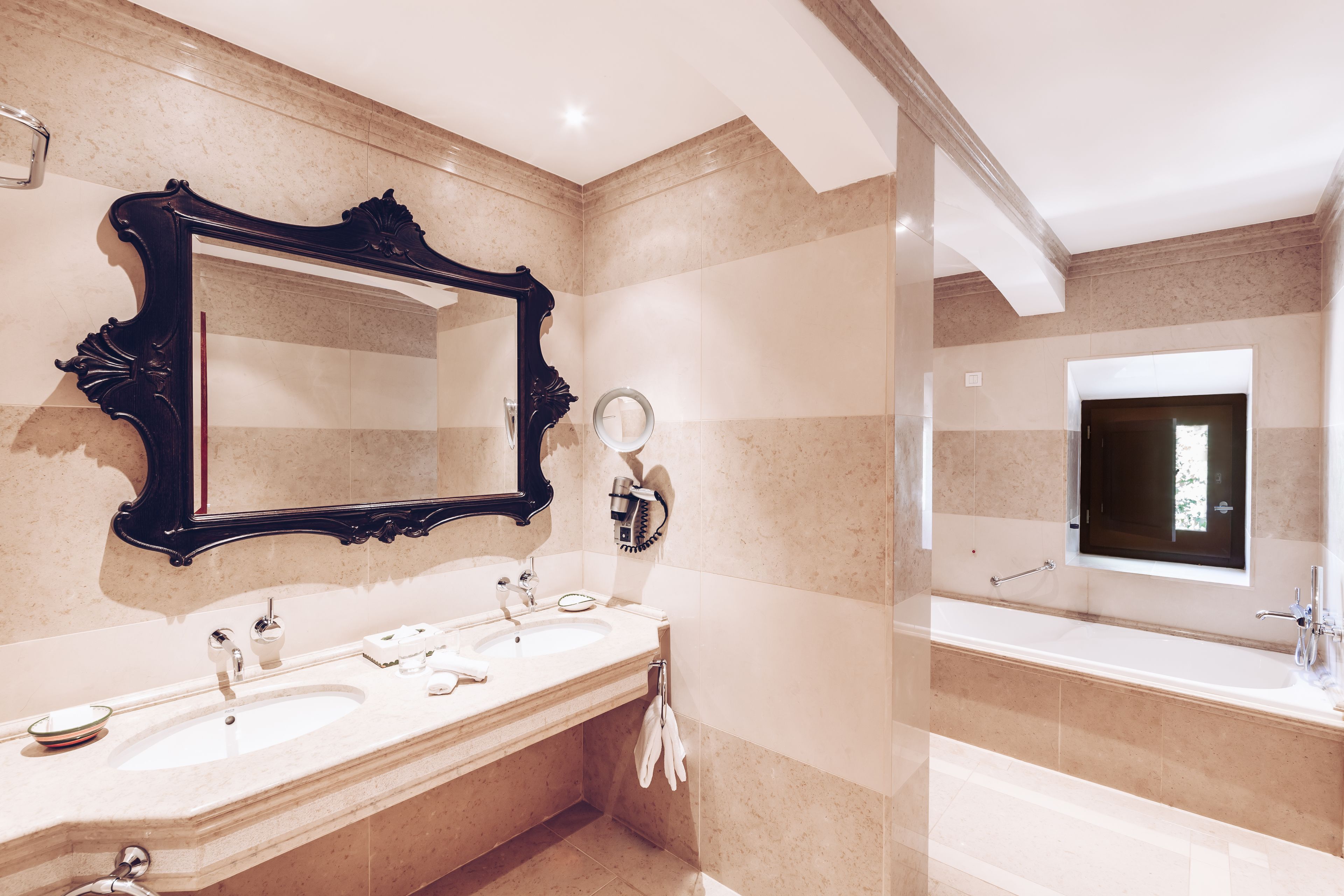 deluxe suite | bathroom | separate bathtub and shower, rainfall showerhead, hair dryer, bathrobes