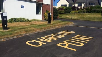 Un área de estacionamiento con un letrero que dice 'CHARGING POINT'.