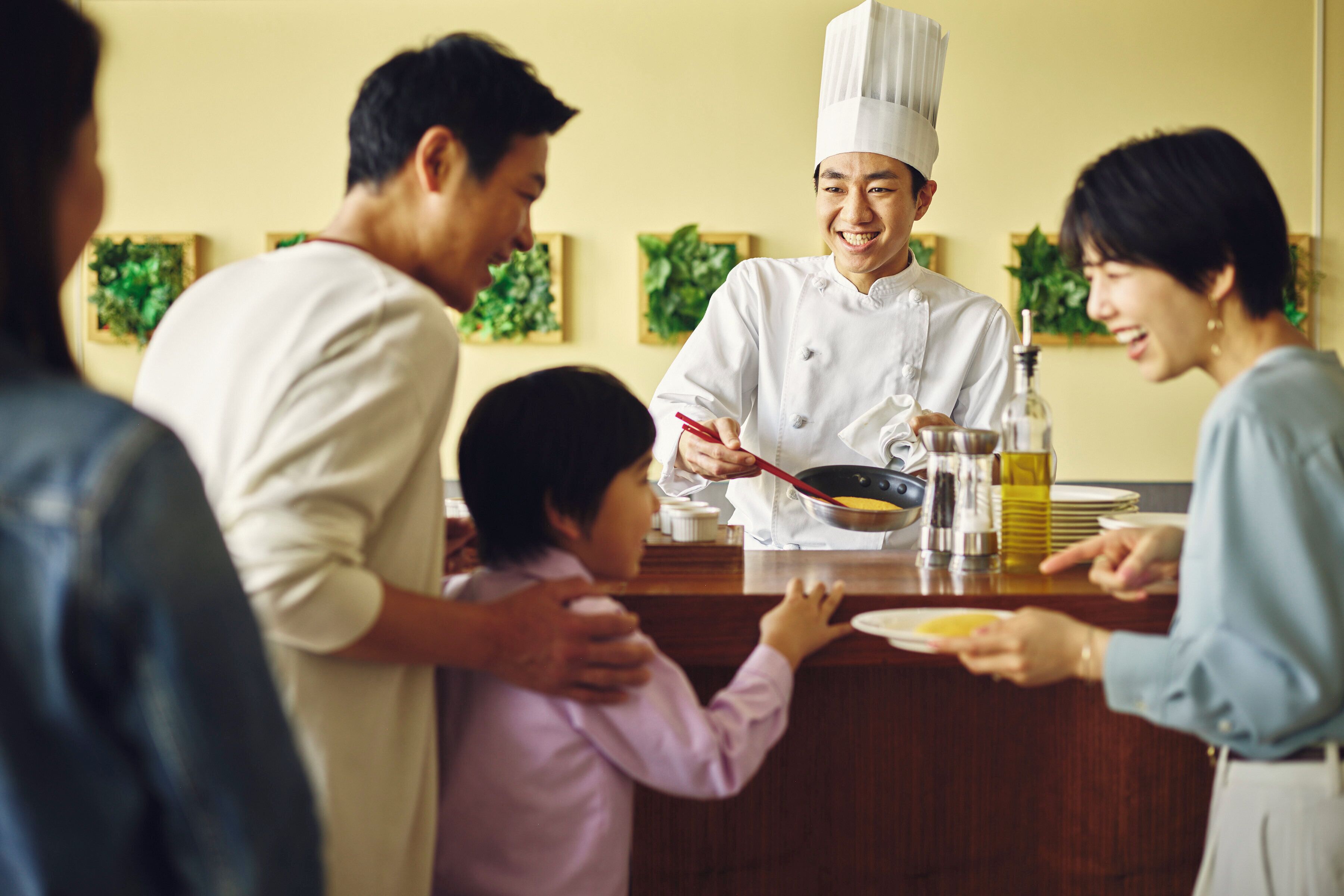 A chef preparing food at a counter in a restaurant.