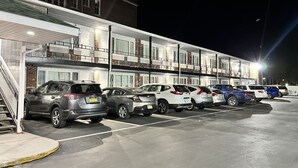 A multi-story parking garage with several cars parked. - Inn Towne Motel (Herkimer)