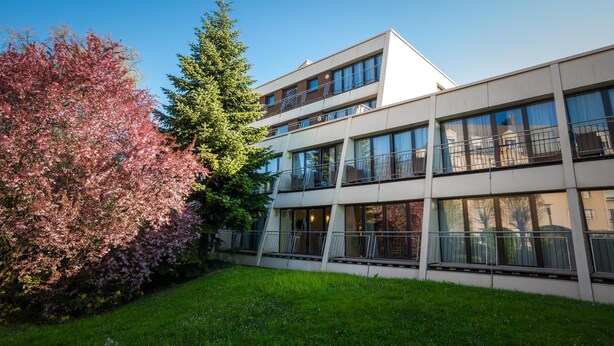 A modern multi-story building with large windows and balconies. - Hotel Parc Plaza (Luxembourg City)