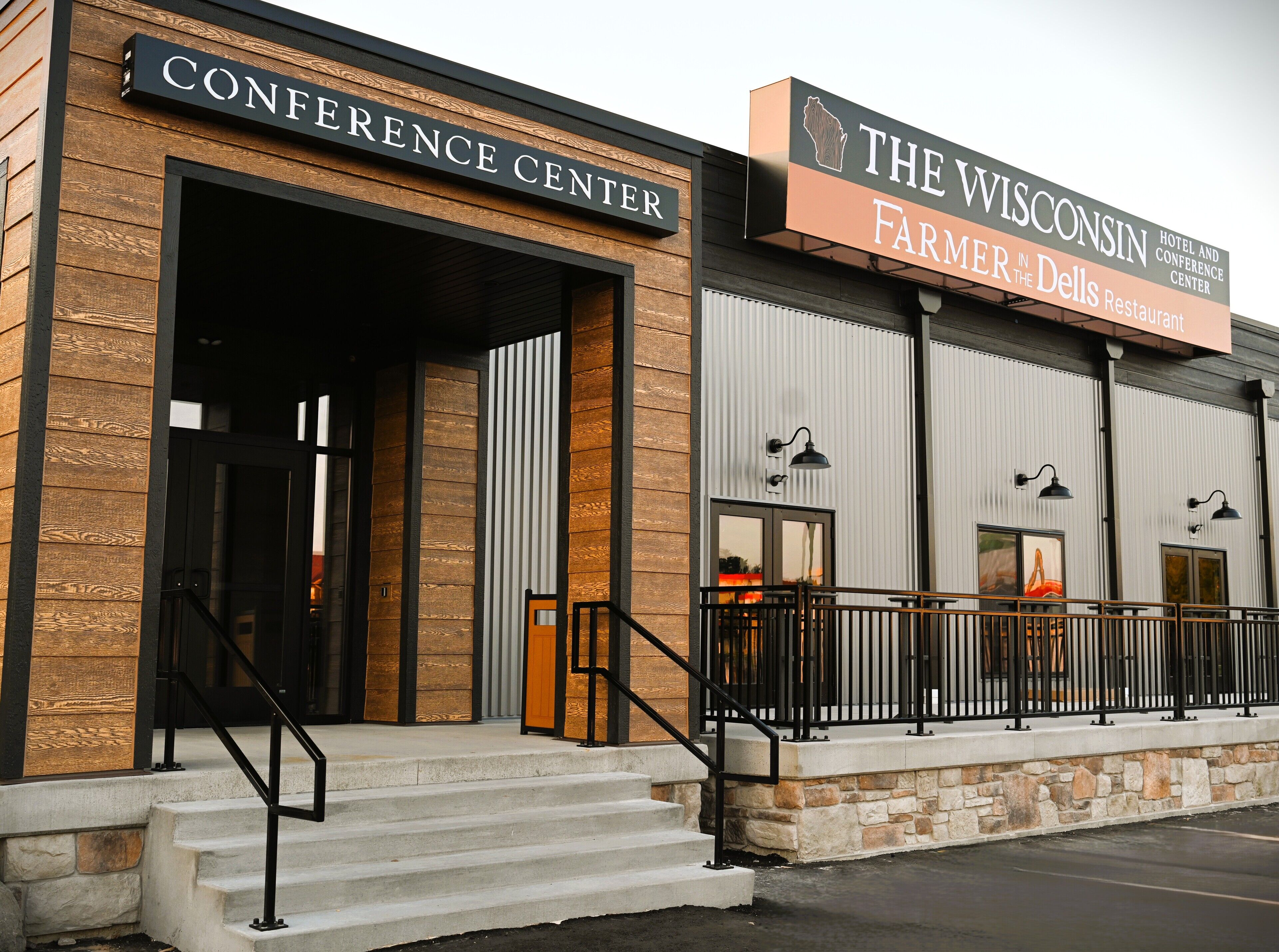 A building with a wooden facade and a sign for 'The Wisconsin Farmer in the Dells Restaurant'.