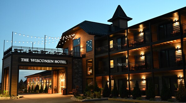 A multi-story hotel with a prominent entrance labeled "The Wisconsin Hotel."