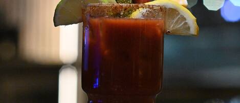 A Bloody Mary cocktail with garnishes, served in a tall glass.