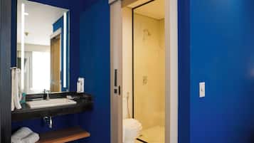 A bathroom with a sink, mirror, and toilet.