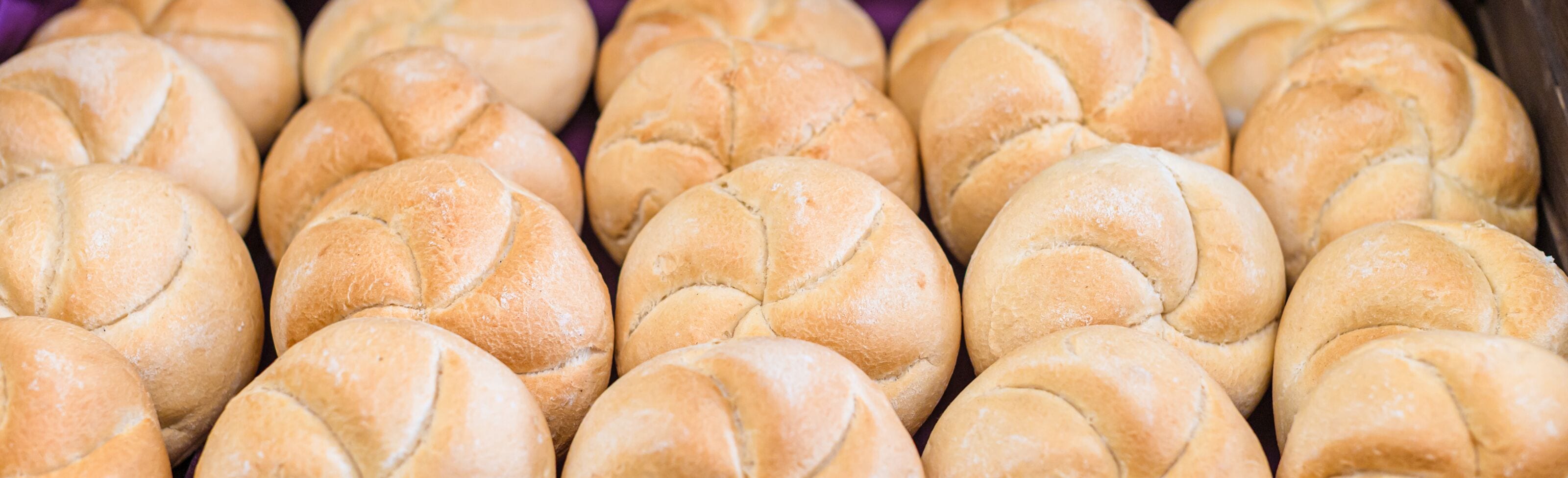 A tray of freshly baked bread rolls.