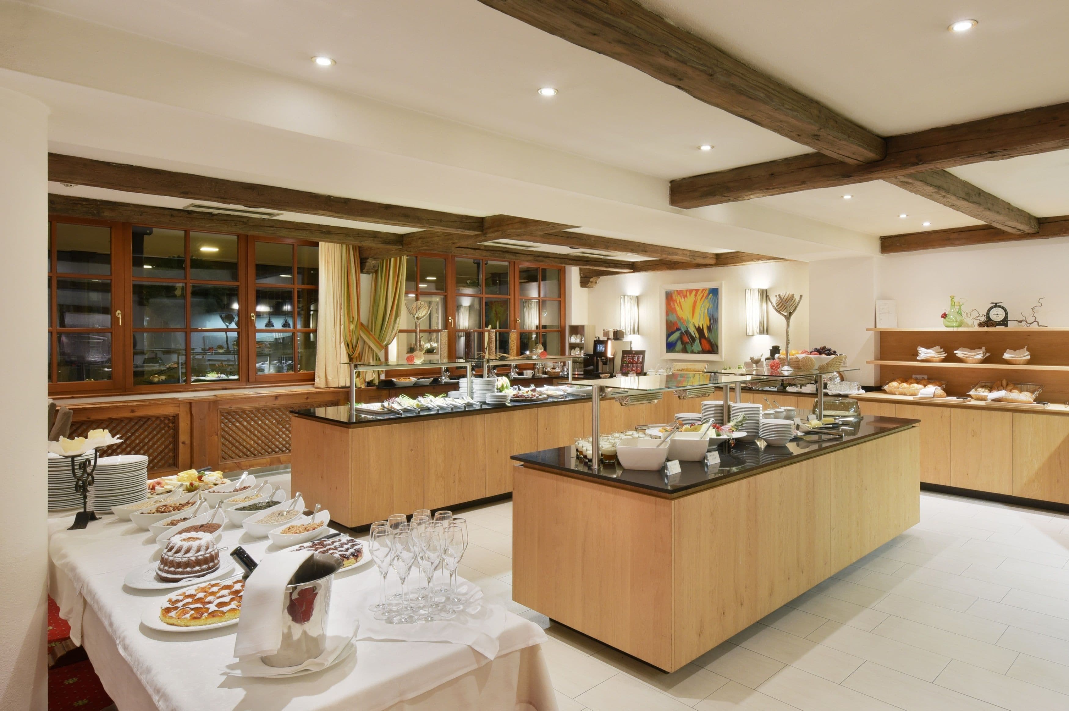 A buffet setup with various food items and glassware.