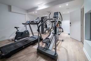 A modern gym with treadmills, elliptical machines, and weight equipment. - Grand Hotel Normandy by CW Hotel Collection (Bruges)