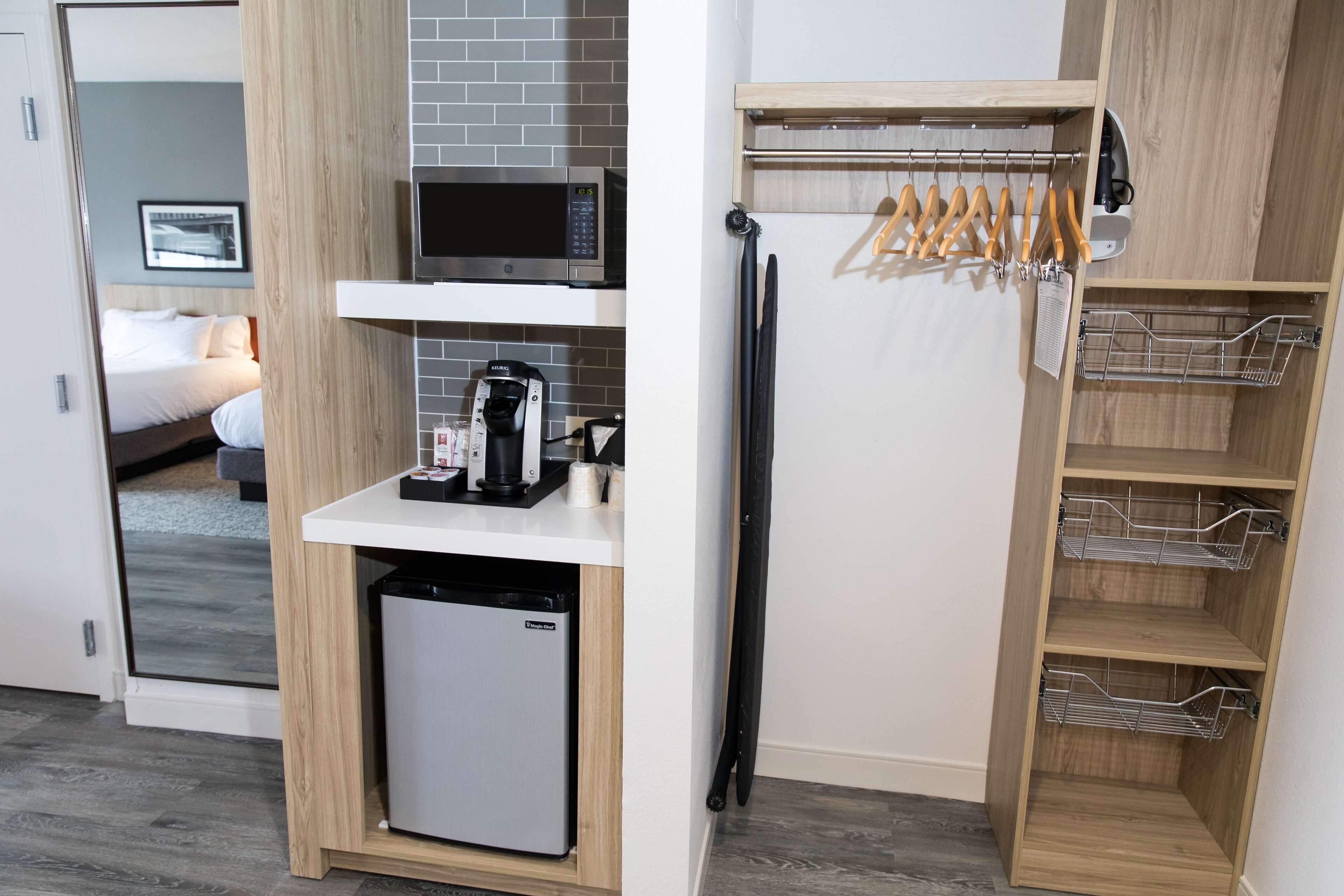 A compact kitchenette with a microwave, coffee maker, and a mini-fridge.