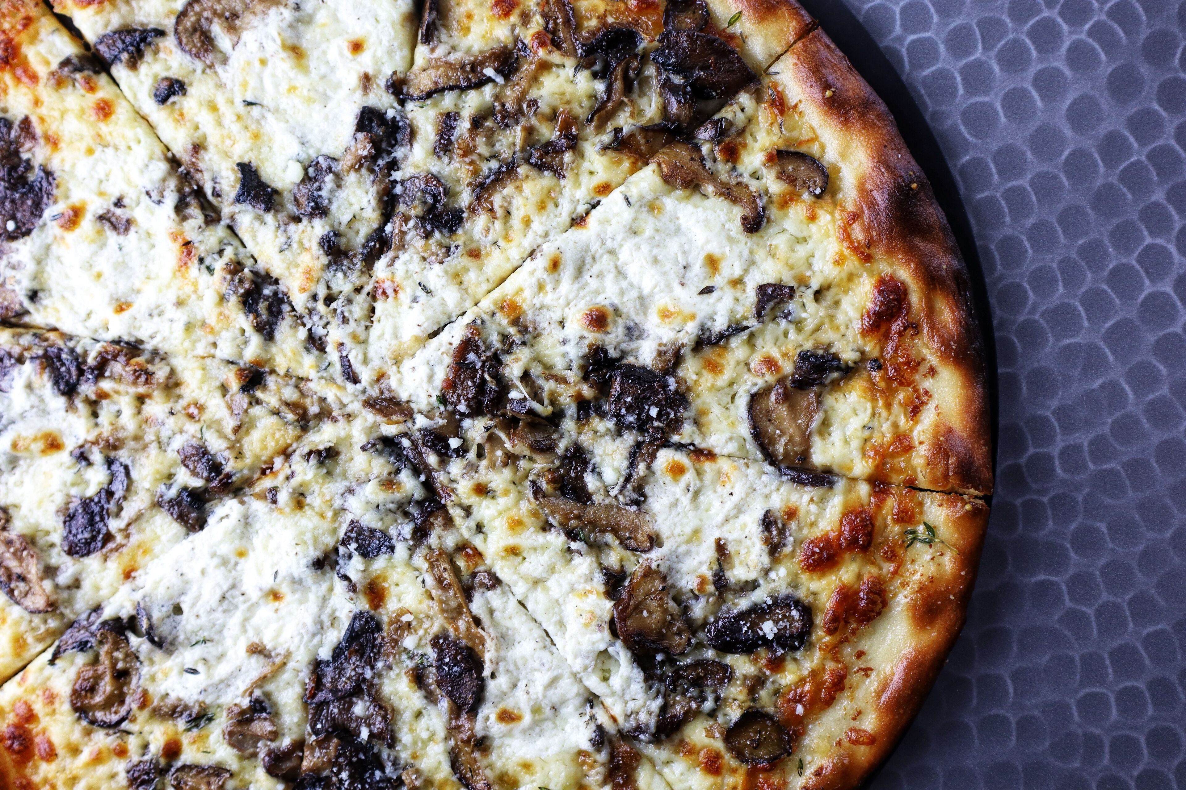 A pizza with visible toppings and a crust.