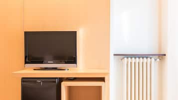 A compact kitchenette with a built-in refrigerator, a microwave, and a small sink.
