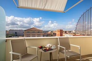 Enjoy tea on the balcony with a view of the city's historic buildings.