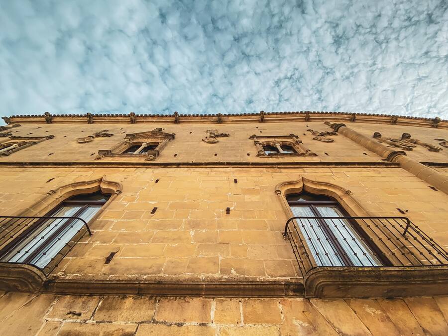 A historic building with arched windows and a balcony.