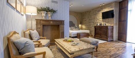 A spacious living room with a fireplace, comfortable seating, a coffee table, and a stone accent wall.