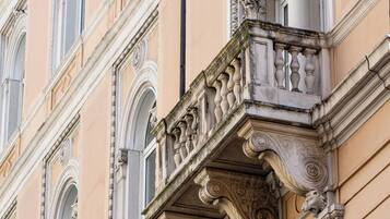 A building facade with ornate architectural details, including arched windows and decorative stonework.