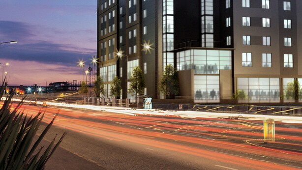 A modern multi-story building with a prominent glass facade, a flat roof, and a series of balconies. - Leonardo Hotel Nottingham  (Nottingham)