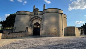 A historic stone building with a central arched entrance and two cylindrical towers. - Leonardo Hotel Nottingham  (Nottingham)