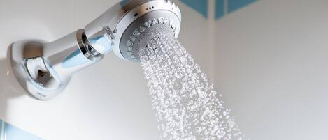A showerhead with water flowing down.
