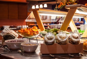 A buffet setup with various food items and condiments.