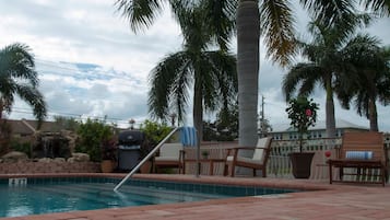 Outdoor pool, a heated pool, open 7:00 AM to 8:00 PM, pool loungers