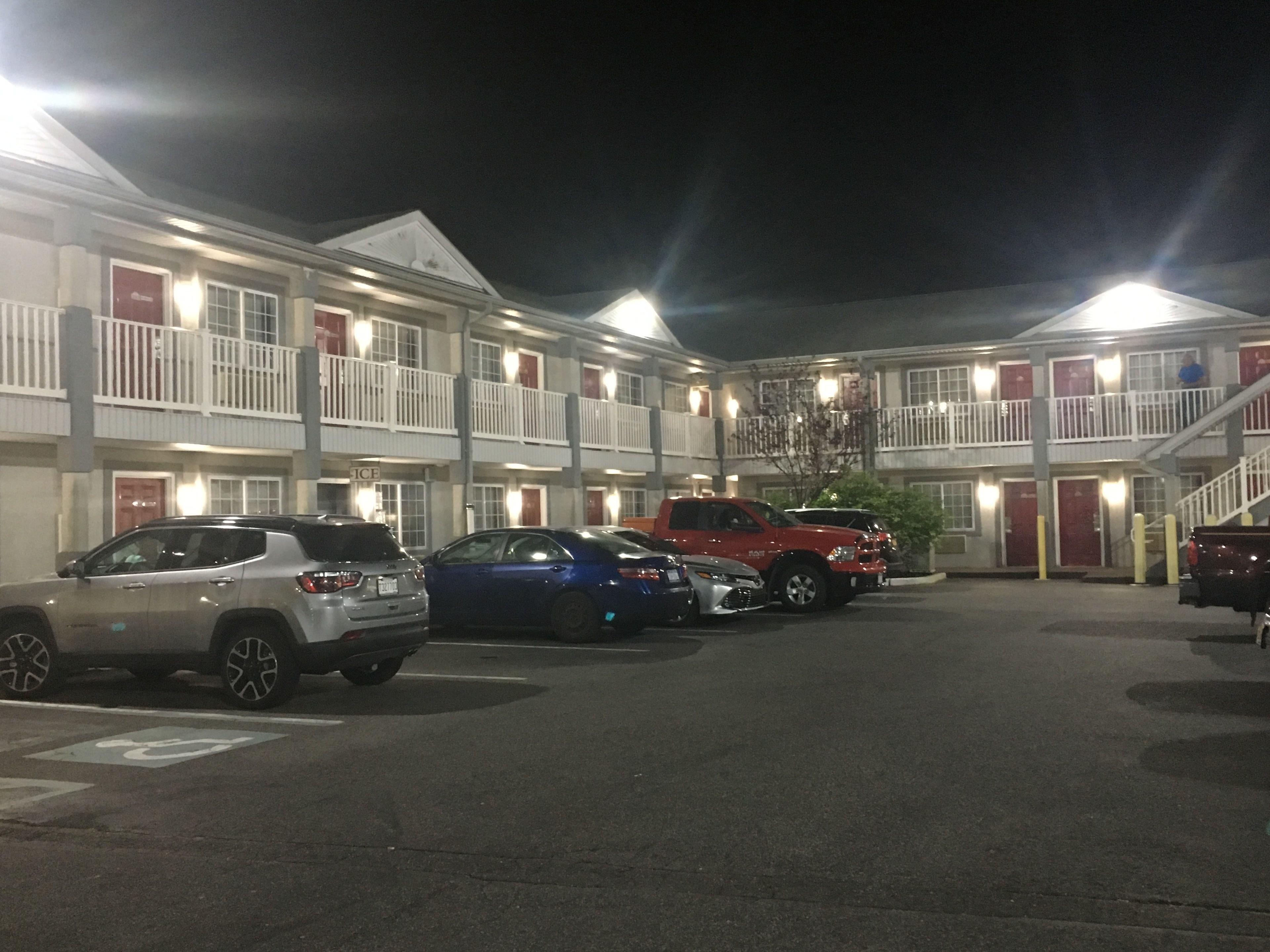 A motel with multiple floors, each with balconies and a central courtyard.