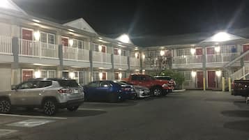 A motel with multiple floors, each with balconies and a central courtyard.