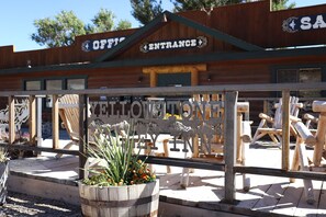 A wooden building with a sign reading "OFFICE ENTRANCE" and "YELLOWSTONE EYE INN" in front.