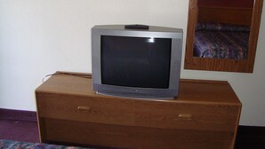 A television on a wooden dresser in a hotel room. - Willow Springs Motel (Cheney)