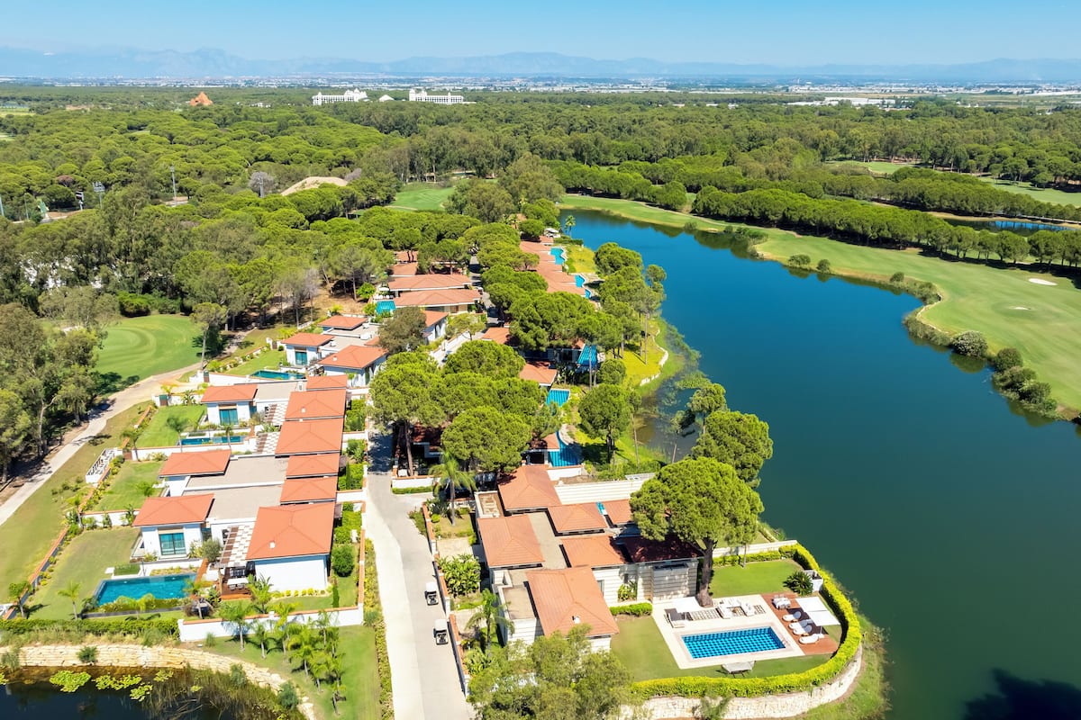 A residential area with houses, a swimming pool, and a golf course.