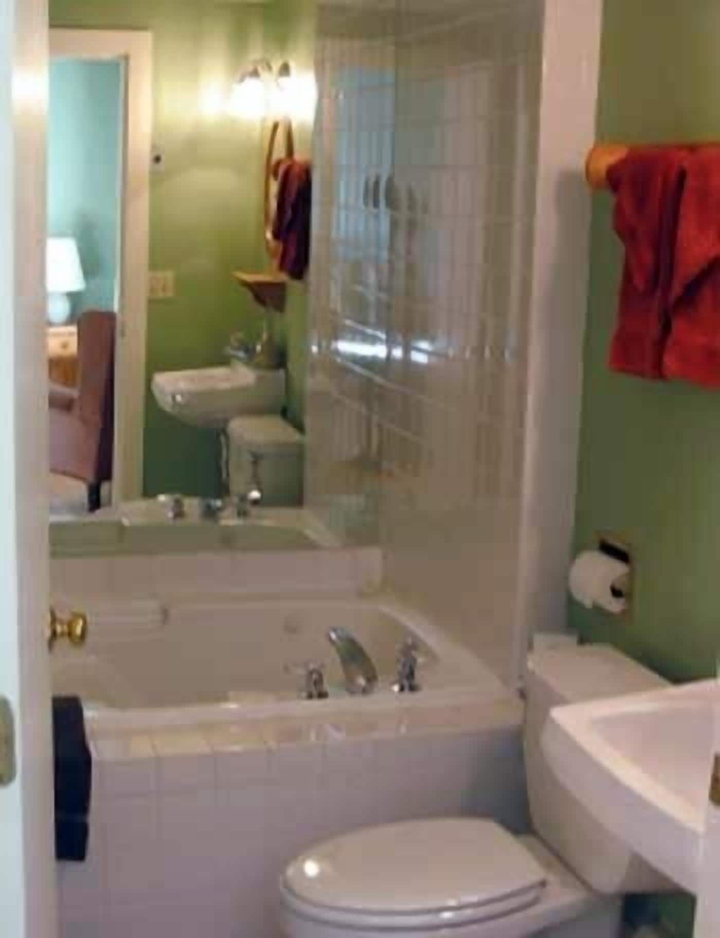 A bathroom with a bathtub, toilet, and sink.