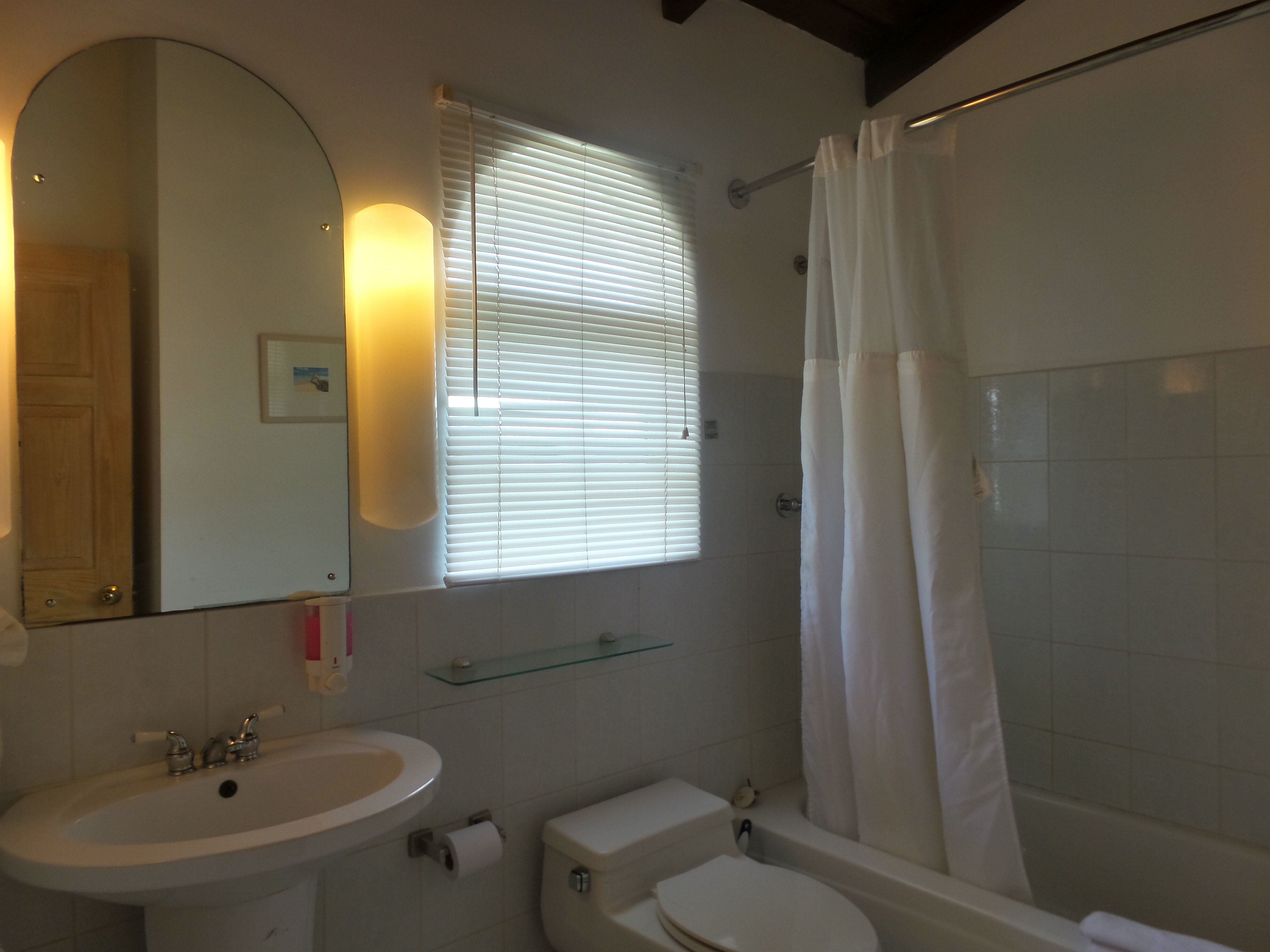 A bathroom with a sink, toilet, and bathtub.