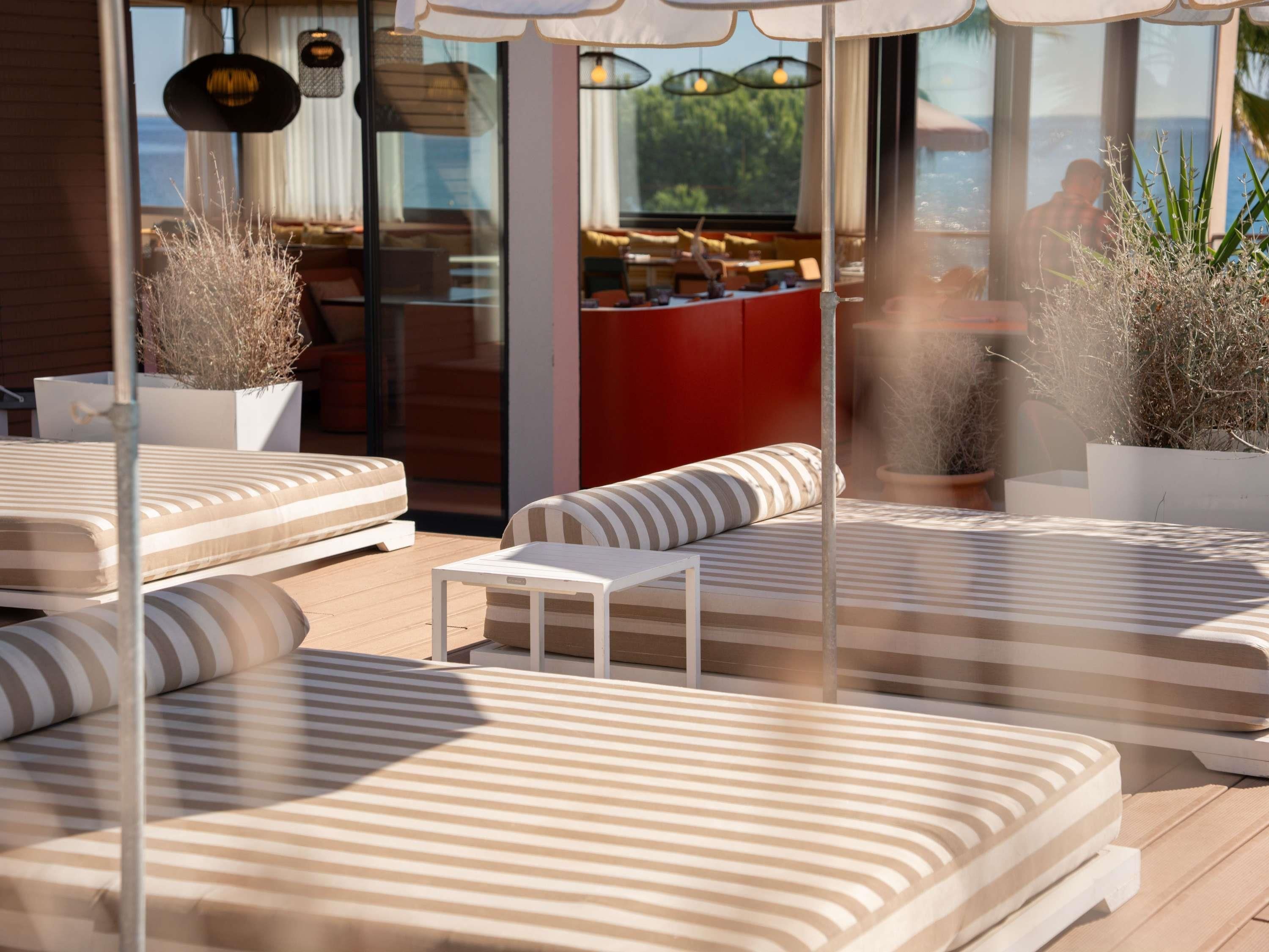 A modern outdoor seating area with striped cushions and planters.