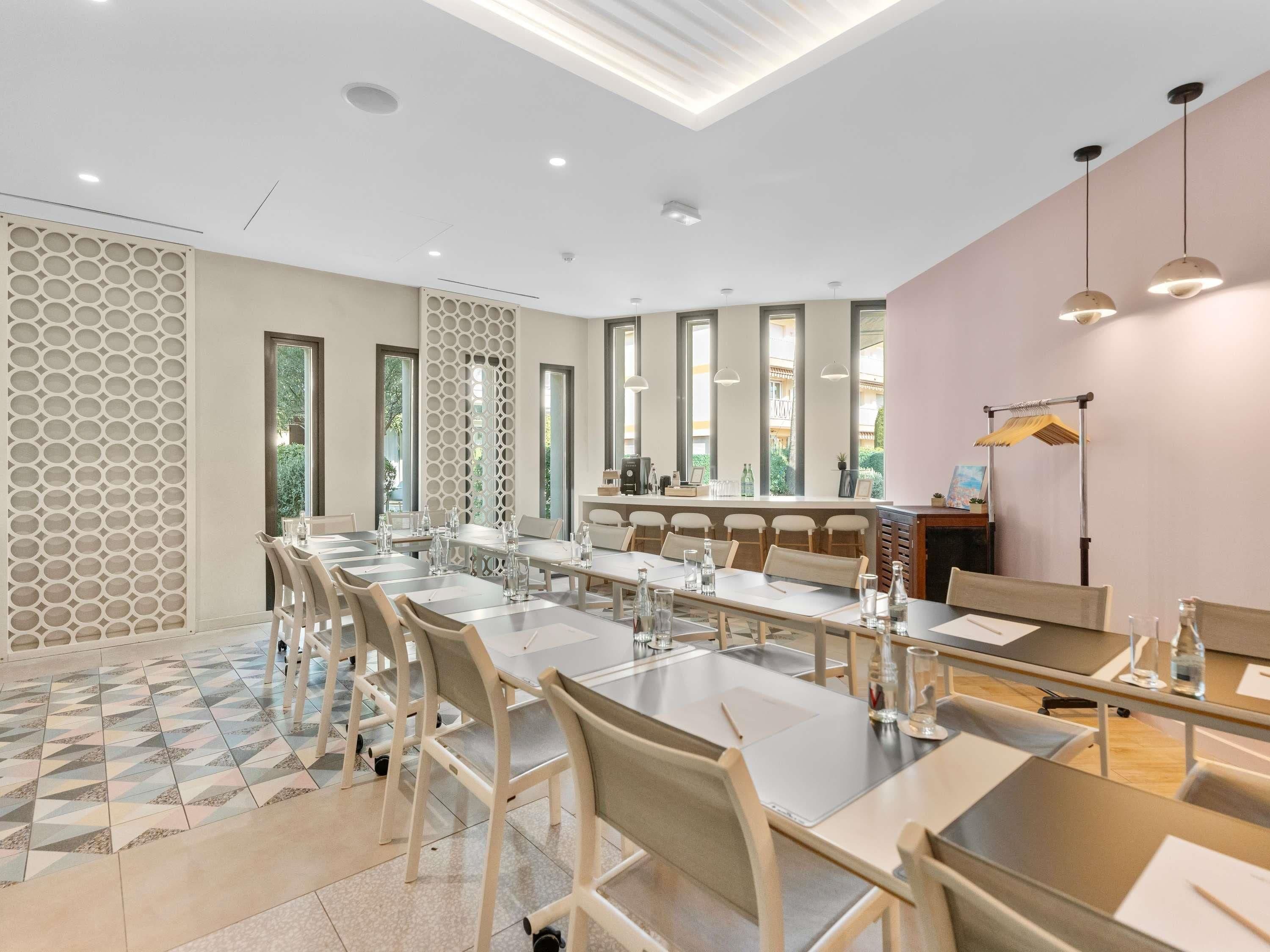 A modern conference room with a long table, chairs, and a decorative wall panel.