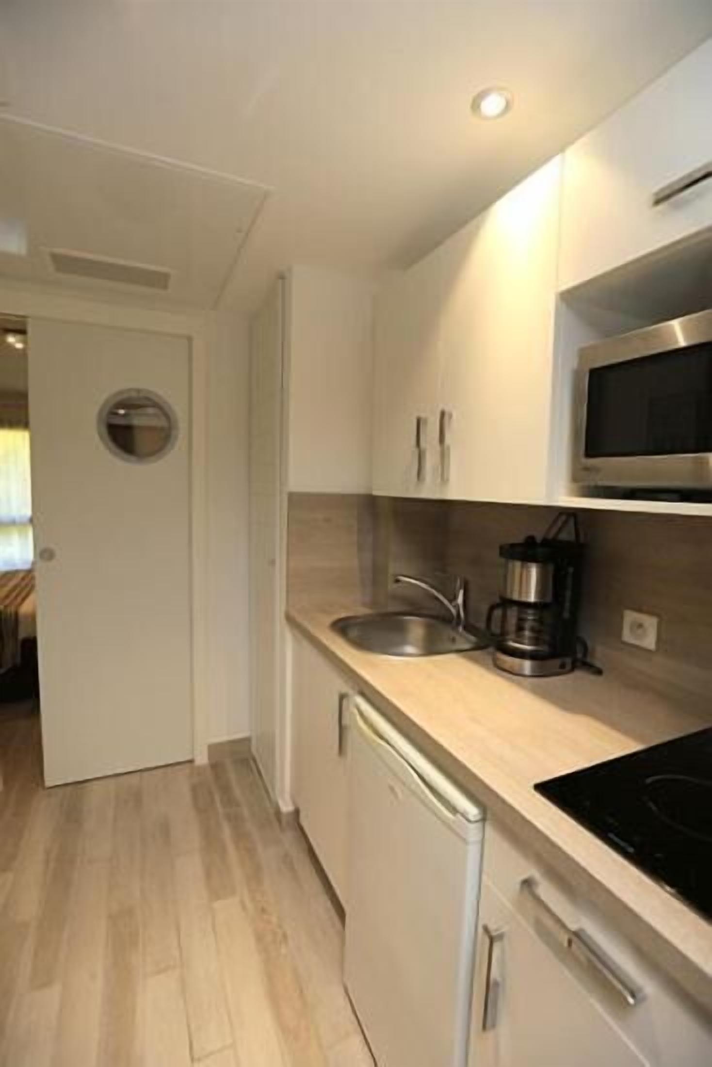 mini-fridge, microwave, stovetop, espresso maker