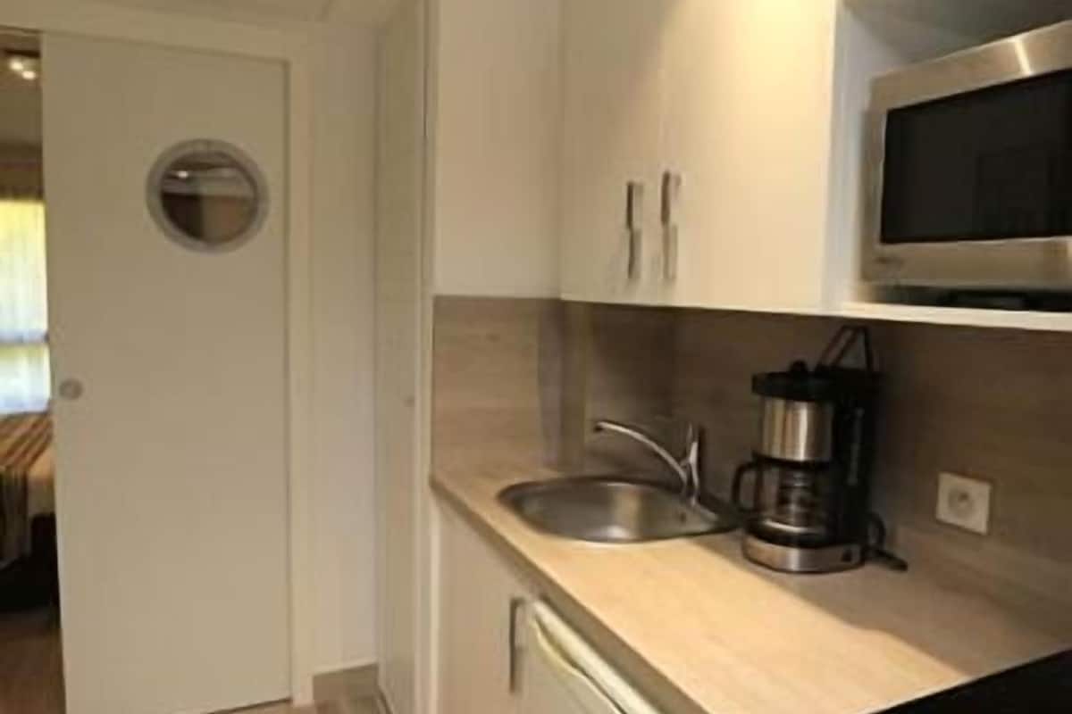 mini-fridge, microwave, stovetop, espresso maker