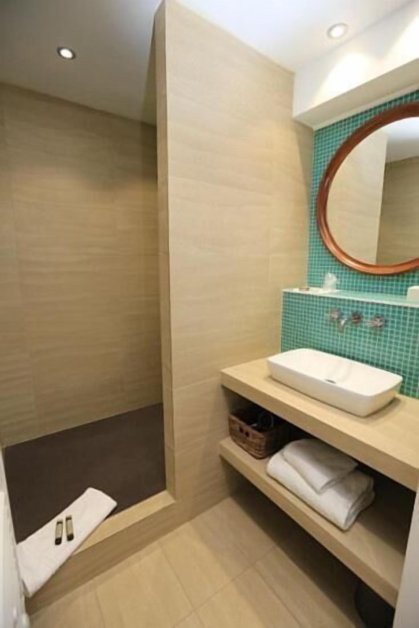 A bathroom with a bathtub, a sink, and a mirror.