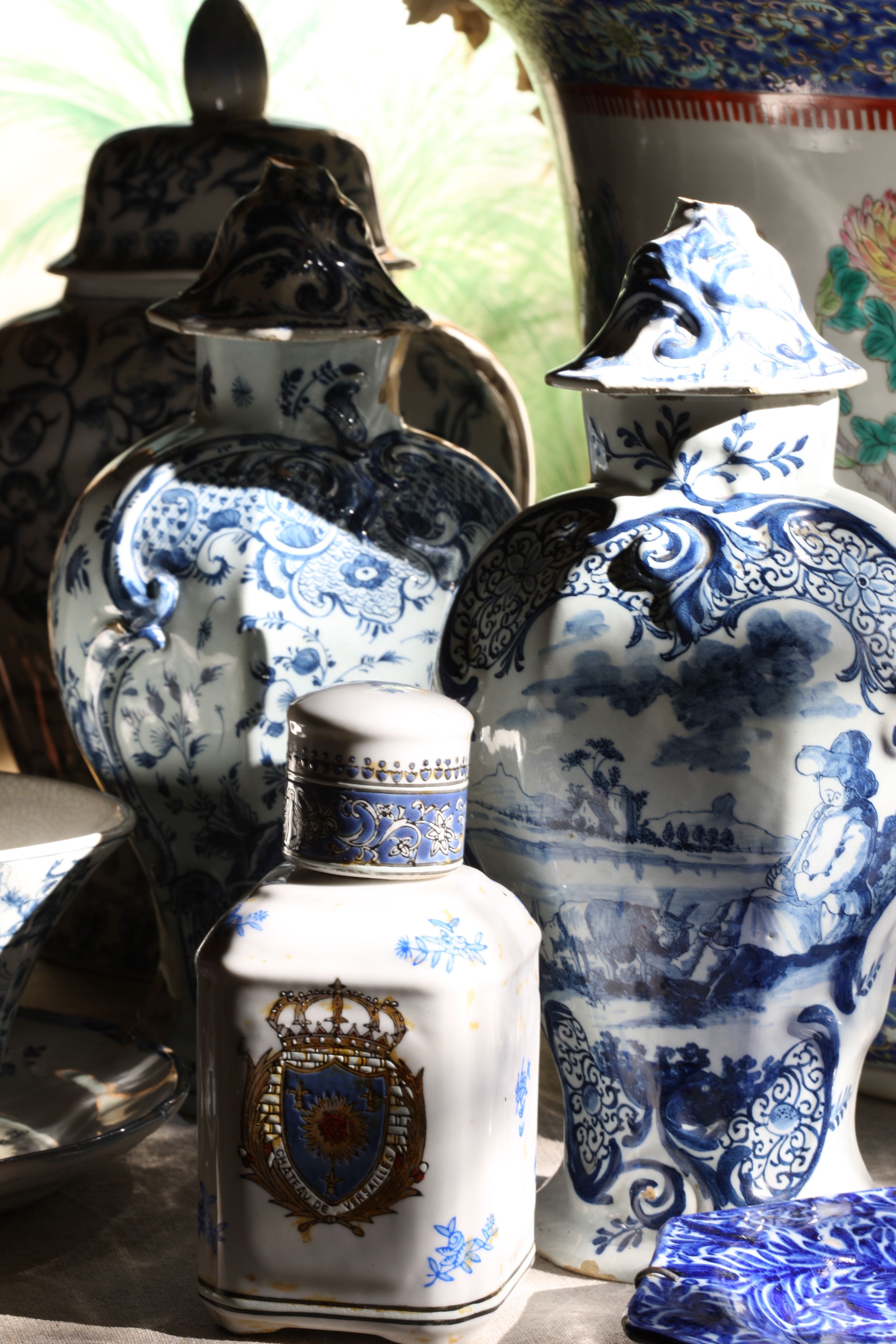 A collection of ornate ceramic containers with intricate blue designs and gold accents.