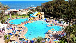 A resort with multiple swimming pools, a water slide, and a view of the ocean. - Marhaba Royal Salem (Sousse)