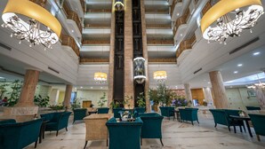 A spacious lobby with high ceilings, marble flooring, and multiple seating areas. - Marhaba Royal Salem (Sousse)