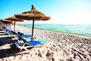 Private beach, white sand, sun loungers, beach umbrellas