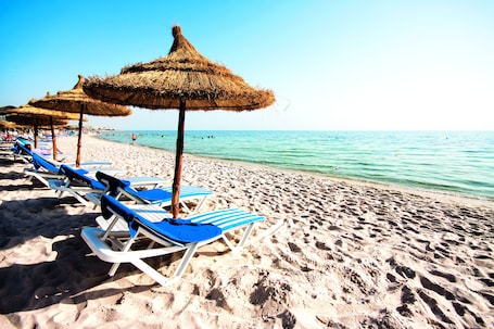 Private beach, white sand, sun loungers, beach umbrellas