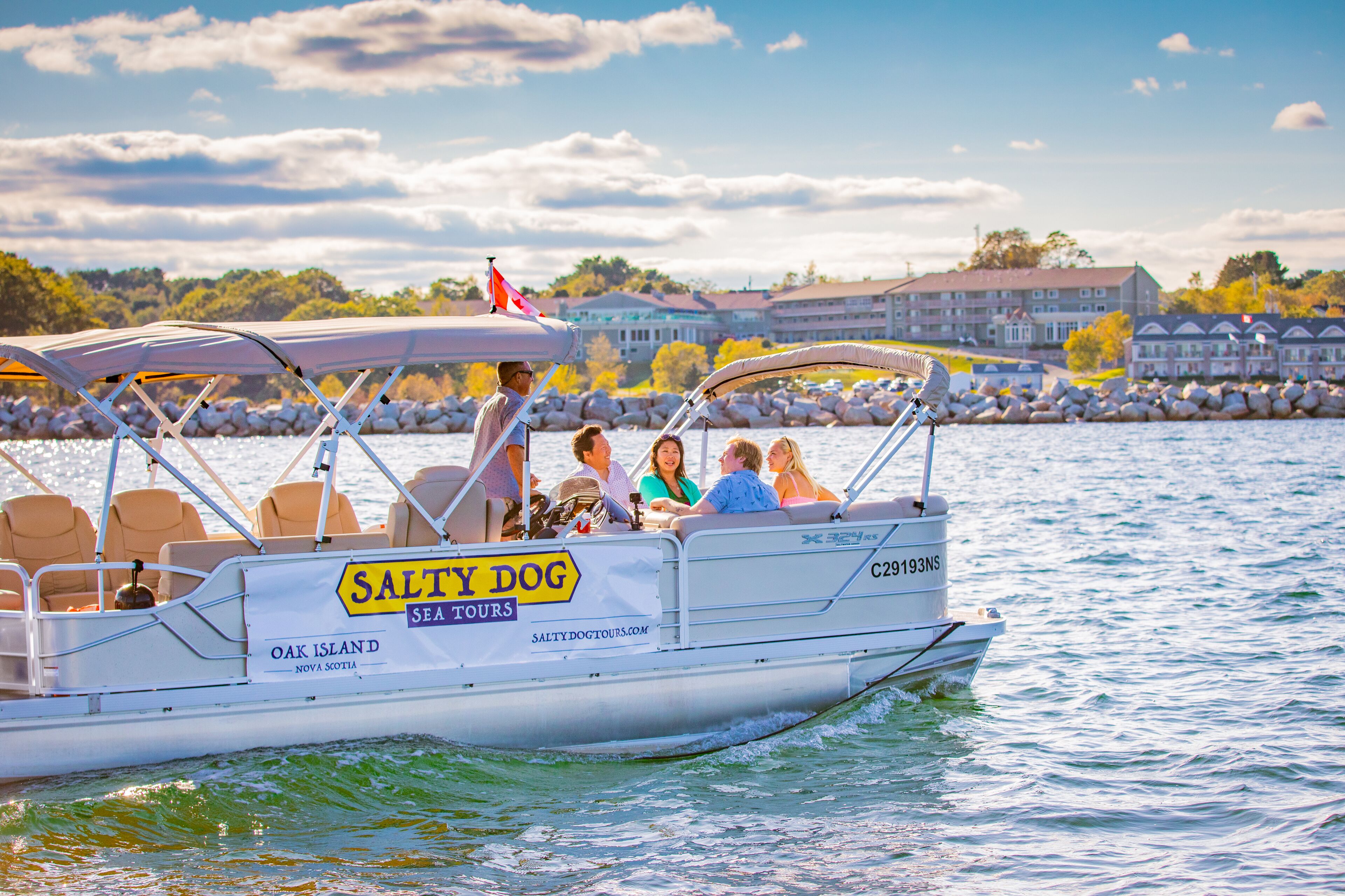 A boat with a sign reading "SALTY DOG SEA TOURS" and "OAK ISLAND NOVA SCOTIA".