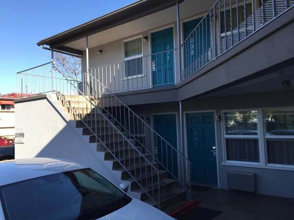 A two-story building with a staircase leading to the upper floor.