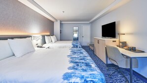 A hotel room with two beds, a desk, a TV, and a mirror. - The Bridgeway (Buzzards Bay)