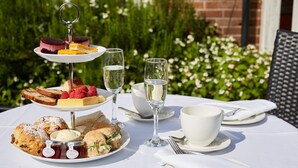 A table set for a meal with various dishes, glasses of water, and a white tablecloth. - The Lismoyne Hotel (Fleet)