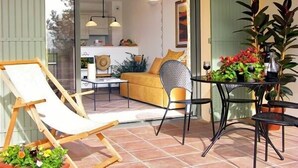 An open-plan living area with a sofa, chairs, and a dining table.
