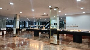 A spacious lobby with a polished marble floor, large mirrors, and a buffet area with various food items. - Lloret Vibe Affiliated by FERGUS (Lloret de Mar)
