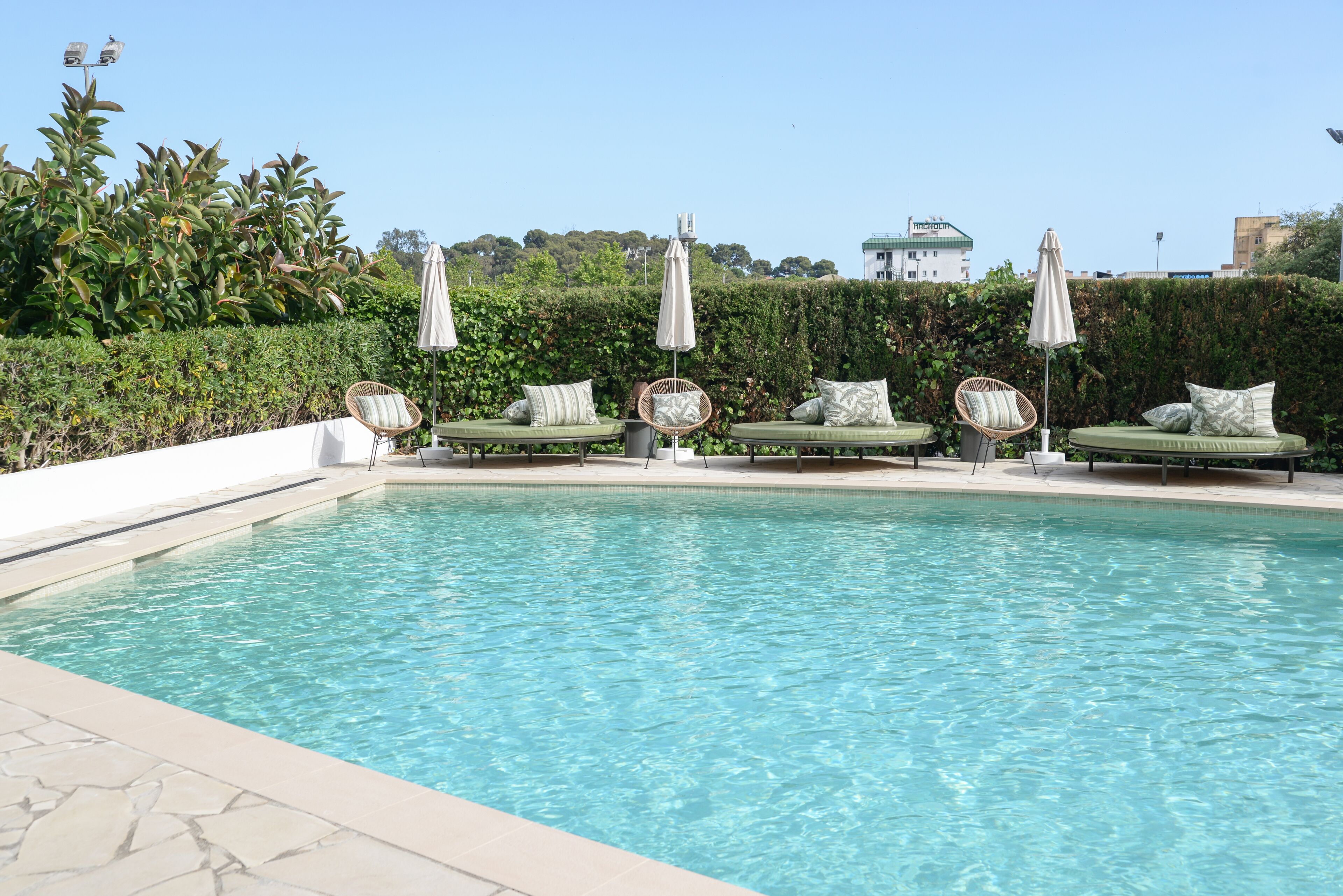 outdoor pool, open 10:00 am to 7:00 pm, pool umbrellas, pool loungers