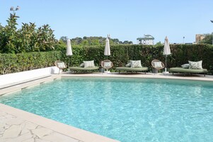 Outdoor pool, open 10:00 AM to 7:00 PM, pool umbrellas, sun loungers